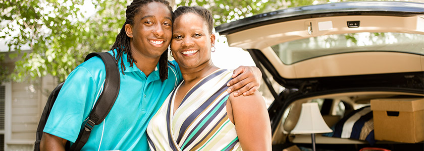 Son hugging mom at college drop-off