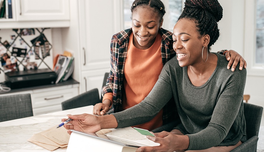 Mother and child reviewing finances